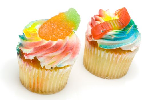 Funny and colorful cupcakes decorated with candies for children party on white background