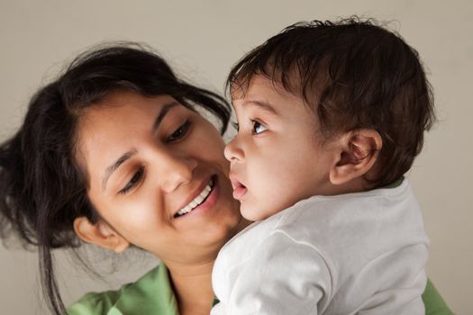 Indian Happy mother and baby looking at others