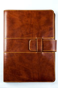 brown notebook on white background