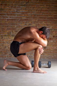 muscle shaped man on knee thinking with thinker posture