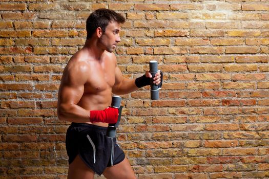 muscle boxer man with fist bandage and training weights