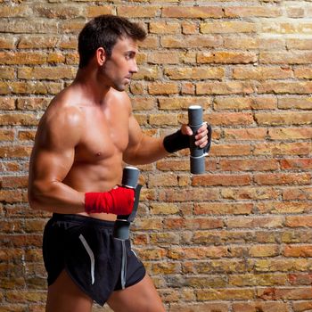 muscle boxer man with fist bandage and training weights