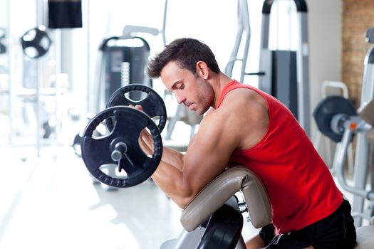 man with weight training equipment on sport gym club