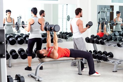 group of people in sport fitness gym weight training equipment indoor