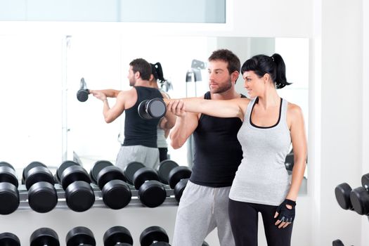 gym woman personal trainer man with weight training equipment