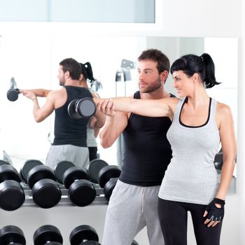 gym woman personal trainer man with weight training equipment