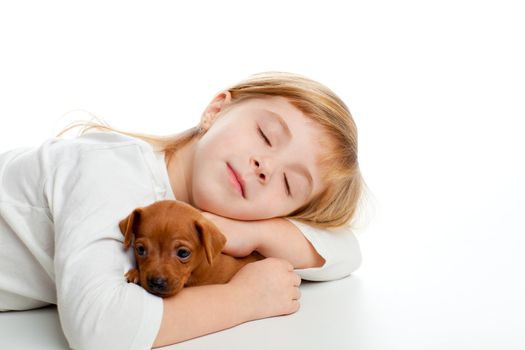 blond kid girl sleeping with mini pinscher pet mascot dog on white background