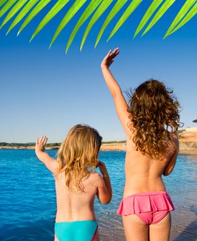Ibiza Cala Conta beach little girls greeting hand sign saying bye