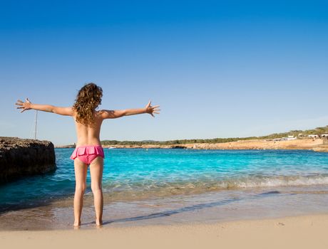 Ibiza Cala Conta beach open arms little girl happy in summer vacation