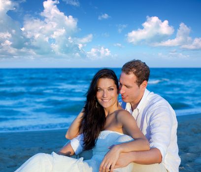 couple in love sitting in blue beach on vacation travel