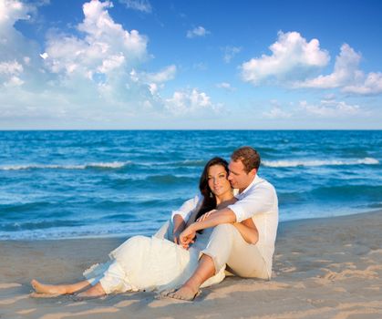couple in love sitting in blue beach on vacation travel