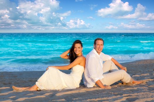 couple in love sitting in blue beach on vacation travel