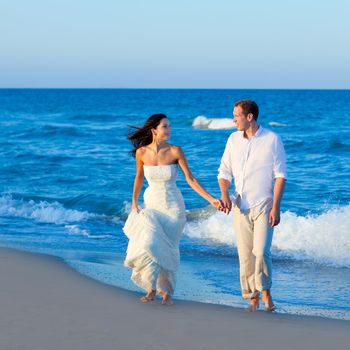Mediterranean couple walking in blue beach shore