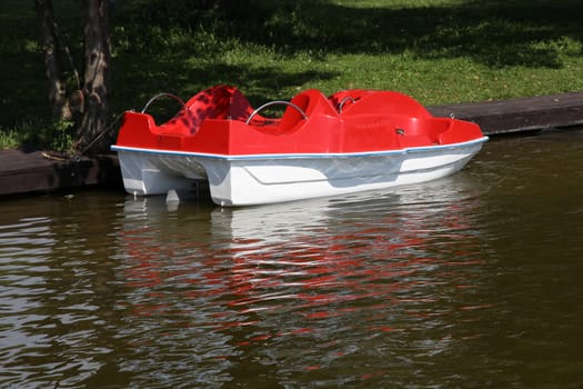 Masuria (Mazury) - famous lake district in Poland. Red paddle boat (pedalo). Wydminskie lake.