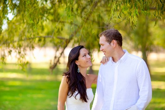 couple in love happy in green park outdoor under trees