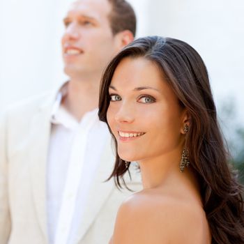 Happy beautiful woman portrait with man in blur background