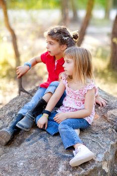 friends kid girls playing in forest rock outdoor