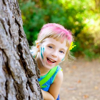 children little girl happy playing in forest tree with party makeup