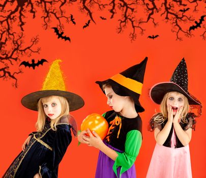 Halloween group of children girls costumes on orange background