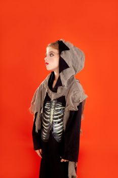 Halloween kid girl costume on orange background