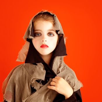 Halloween kid girl costume on orange background