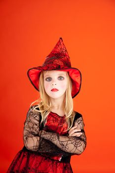 Halloween kid girl costume on orange background