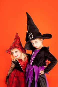 Halloween sister kid girls on orange background