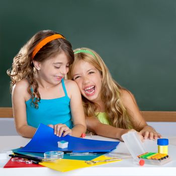 happy laughing student girls group at school classroom desk