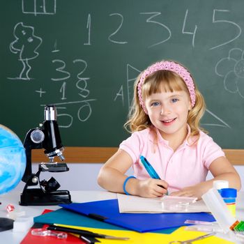 children little girl at school classroom with microscope in science class