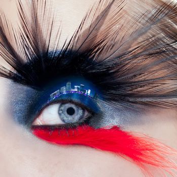 blue woman eye makeup bird inspired with black and red feathers and night city in eyelid