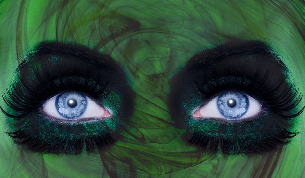 abstract blue woman eyes makeup with a green texture skin