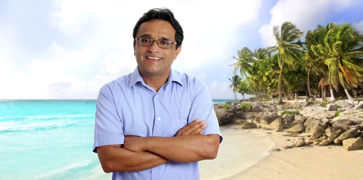 Indian man tourist portrait in tropical caribbean beach with palm trees