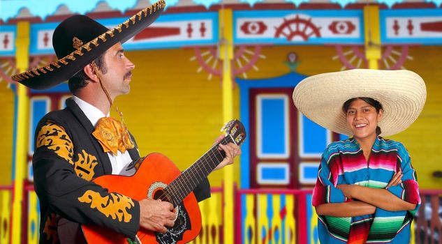 Mexican mariachi charro man and poncho Mexico girl colorful facade houses