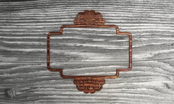 3D graphic Flourish curlicue label symbol  in a wooden textured  background