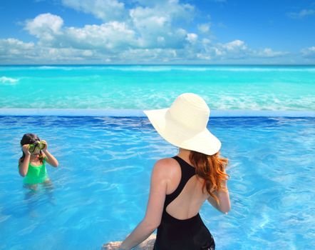 blue swimming pool with direct caribbean view rear motherview and goggles daughter in background