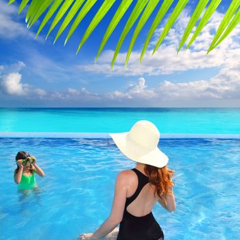 blue swimming pool caribbean view mother and goggles daughter