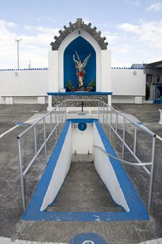 a statue of saint michael slaying the devil with a healing holy well in Lixnaw county Kerry Ireland