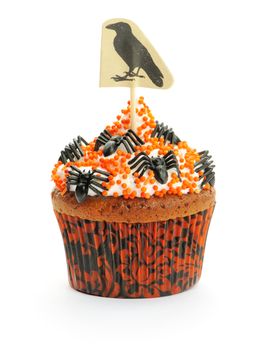 Halloween cupcake with whipped cream and decoration isolated on white