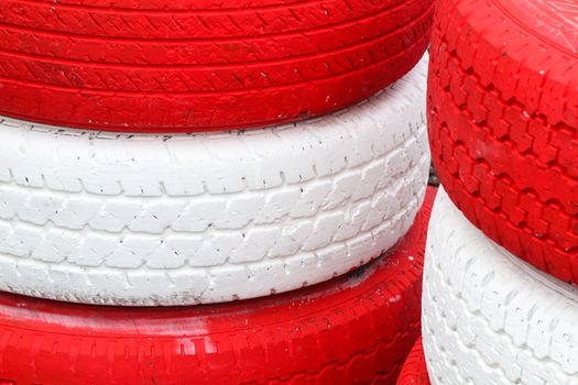 Pile red and white rubber tires for background