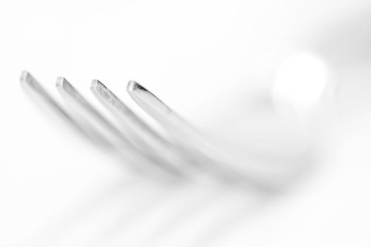 The fork on the white background, shallow depth of field
