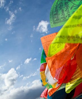 Buddhist tibetan prayer flags flying with blue sky