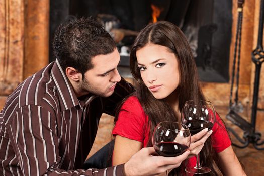 Young couple in love near fireplace