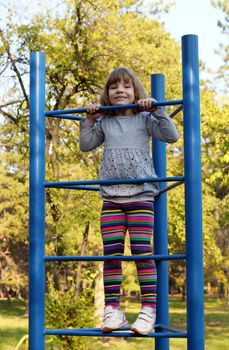 little girl climb on park playground