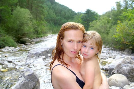 mother daughter playing in river after swimming outdoor nature