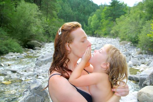 mother daughter playing in river after swimming outdoor nature