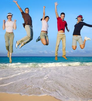 Jumping young people happy group vacation tropical beach