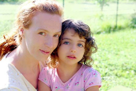 Daughter and mother together outdoor park portrait in nature