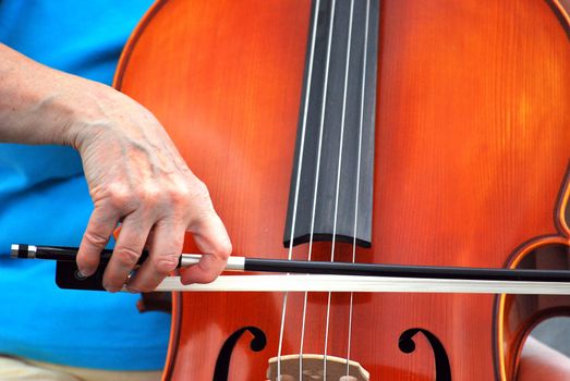 Female cellist performing a classical solo outdoors.