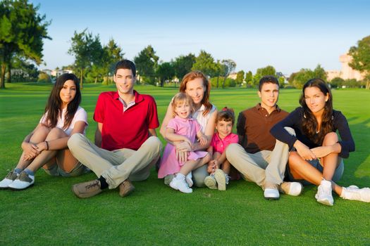 family friends group people sitting green grass outdoor with children