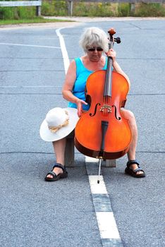 Female cellist performing a classical solo outdoors.